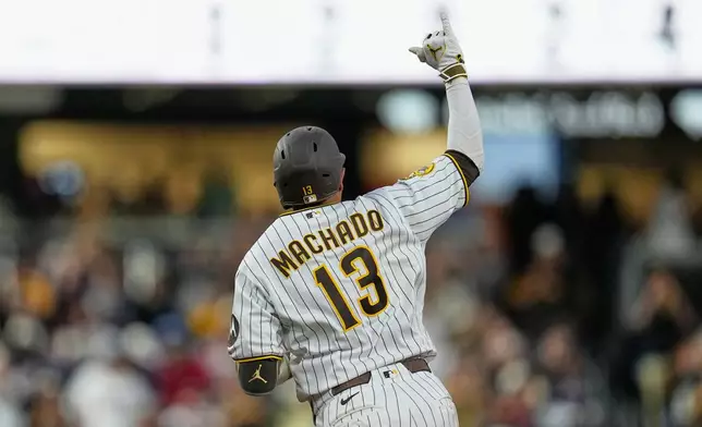 San Diego Padres' Manny Machado celebrates after hitting a home run during the fourth inning of a baseball game against the Atlanta Braves Monday, June 22, 2026, in San Diego. (AP Photo/Gregory Bull)