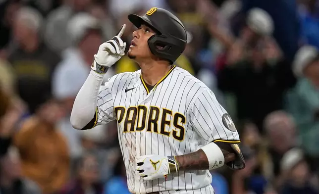 San Diego Padres' Manny Machado celebrates after hitting a home run during the fourth inning of a baseball game against the Atlanta Braves Monday, June 22, 2026, in San Diego. (AP Photo/Gregory Bull)