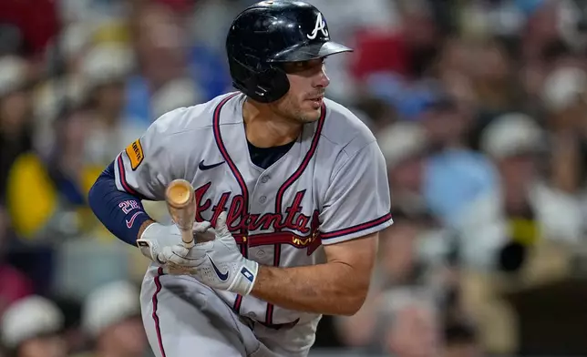 Atlanta Braves' Matt Olson watches his hit for a single during the sixth inning of a baseball game against the San Diego Padres Monday, June 22, 2026, in San Diego. (AP Photo/Gregory Bull)