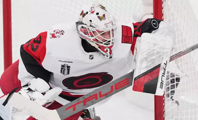 Carolina Hurricanes goaltender Brandon Bussi (32) stops a shot on goal during the first period in Game 6 of the NHL hockey Stanley Cup Final series against the Vegas Golden Knights, Sunday, June 14, 2026, in Las Vegas. (AP Photo/Candice Ward)