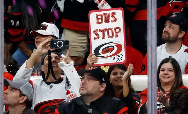 Carolina Hurricanes celebrate goaltender Brandon Bussi (32) starting against Vegas Golden Knights during the first period in Game 5 of the NHL hockey Stanley Cup Final series in Raleigh, N.C., Thursday, June 11, 2026. (AP Photo/Karl DeBlaker)