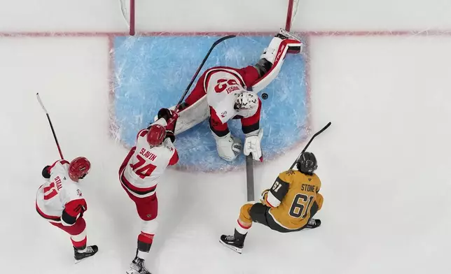 Carolina Hurricanes goaltender Brandon Bussi (32) blocks a shot by by Vegas Golden Knights right wing Mark Stone (61) during Game 6 of the NHL hockey Stanley Cup Final series , Sunday, June 14, 2026, in Las Vegas. (AP Photo/John Locher)
