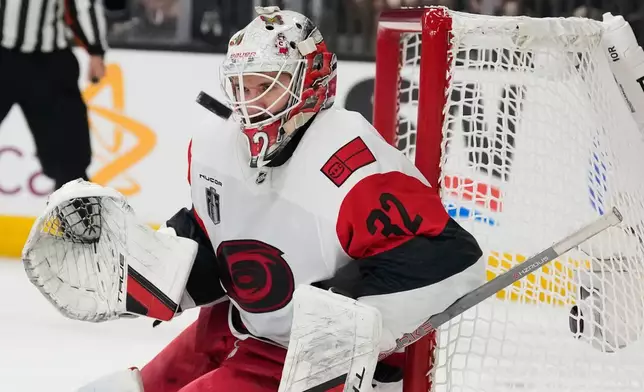 Carolina Hurricanes goaltender Brandon Bussi (32) stops a shot on goal during the second period in Game 6 of the NHL hockey Stanley Cup Final series against the Vegas Golden Knights, Sunday, June 14, 2026, in Las Vegas. (AP Photo/John Locher)