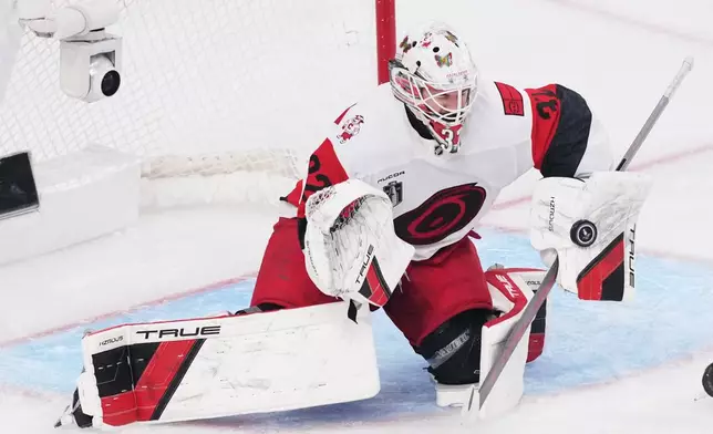Carolina Hurricanes goaltender Brandon Bussi (32) stops a shot on goal during the second period in Game 6 of the NHL hockey Stanley Cup Final series against the Vegas Golden Knights, Sunday, June 14, 2026, in Las Vegas. (AP Photo/Candice Ward)