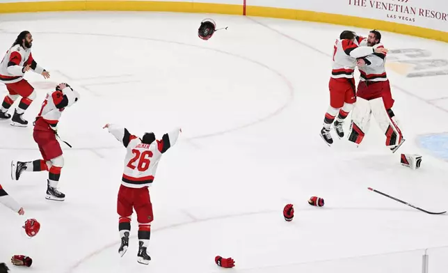 The Carolina Hurricanes celebrates after a win over the Vegas Golden Knights in Game 6 of the NHL hockey Stanley Cup Final series, Sunday, June 14, 2026, in Las Vegas. (AP Photo/Candice Ward)