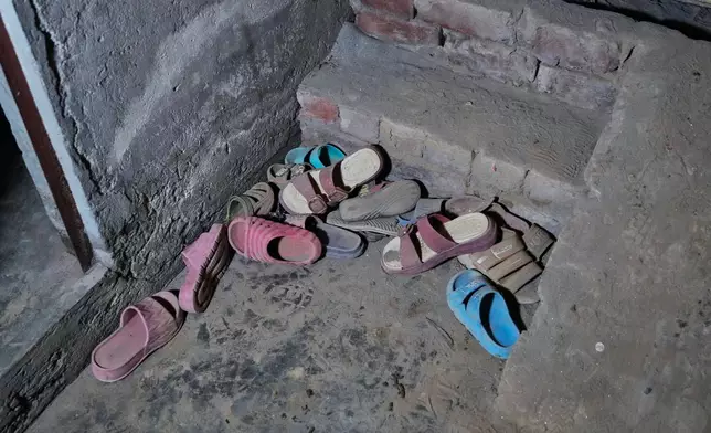 Slippers of the children left behind at the site of an under-construction tutoring center which collapsed, on the outskirts of Lahore, Pakistan, Tuesday, June 30, 2026. (AP Photo/K.M Chaudary)
