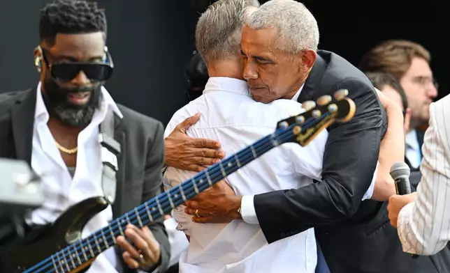Former President Barack Obama, right, embraces Bruce Springsteen during the dedication ceremony for the Obama Presidential Center, Thursday, June 18, 2026, in Chicago. (AP Photo/Jon Cherry)