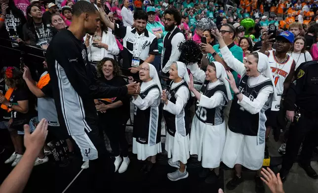 The Salesian Sisters greet players prior to Game 1 of the NBA Finals basketball series between the New York Knicks and the San Antonio Spurs, Wednesday, June 3, 2026, in San Antonio. (AP Photo/Eric Gay)