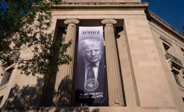 FILE - A giant portrait of President Donald Trump looks down from the Justice Department in Washington, June 2, 2026. (AP Photo/J. Scott Applewhite, File) 