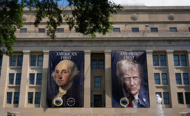 Banners, one of President George Washington that reads "America's First," left, and another of President Donald Trump that reads, "America First," are pictured at the Department of the Interior, Thursday, June 25, 2026, in Washington. (AP Photo/Carolyn Kaster)