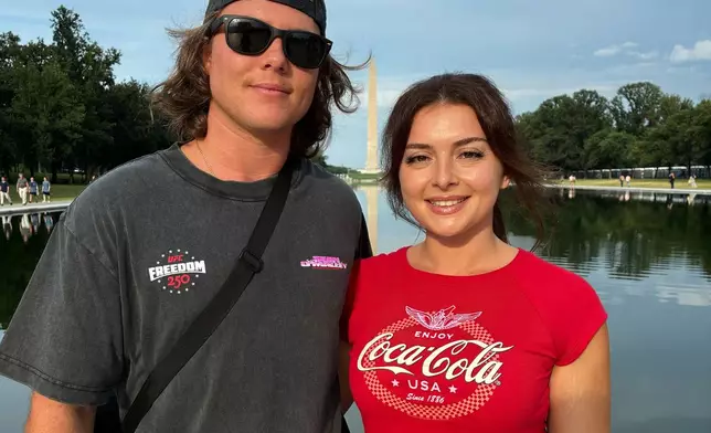Jacob Burvis and Ellie Louizes, from Daytona Beach Fla., pose for a photo at the Lincoln Memorial, Friday, June 12, 2026, in Washington. (AP Photo/Fatima Hussein)