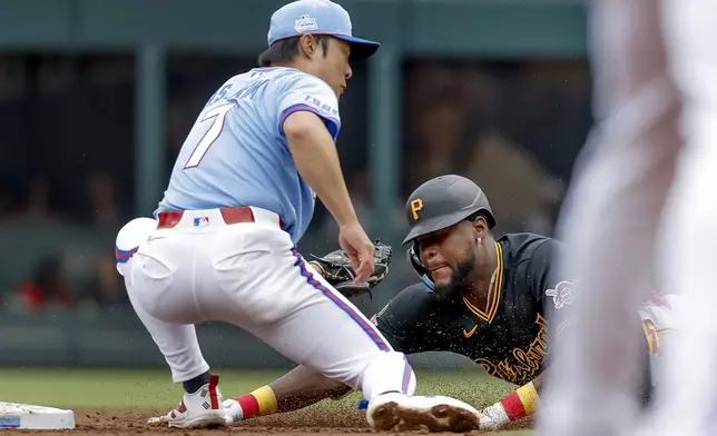 Pittsburgh Pirates' Oneil Cruz, right, steals second base against Atlanta Braves shortstop Ha-Seong Kim, left, during the second inning of a baseball game, Saturday, June 6, 2026, in Atlanta. (AP Photo/Erik S. Lesser)