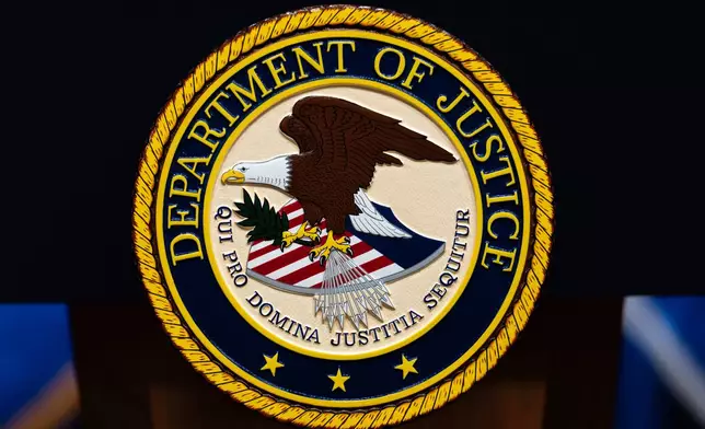FILE - The U.S. Department of Justice logo is seen on a podium before a news conference, May 4, 2026, in Washington. (AP Photo/Julia Demaree Nikhinson, File)