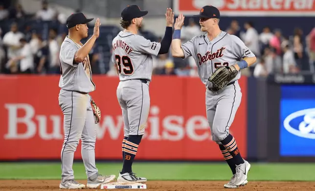 Detroit Tigers' Hao-Yu Lee, left, Zach McKinstry, center, and Ben Malgeri celebrate after defeating the New York Yankees in a baseball game Monday, June 29, 2026, in New York. (AP Photo/Pamela Smith)