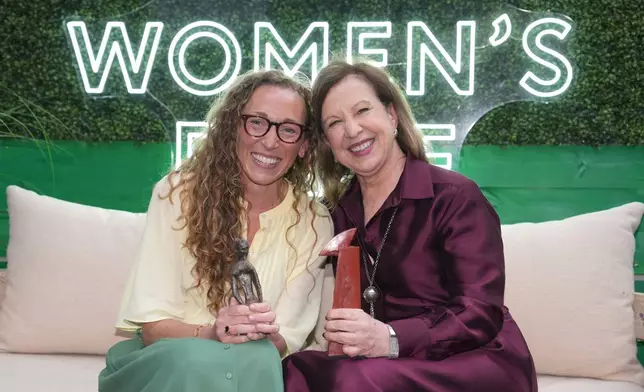 Virginia Evans, left, and Lyse Doucet winners of The Women's Prize for fiction, left, and nonfiction, pose for a photograph at the 2026 Women's Prize Trust Summer Party &amp; Awards Ceremony in London, Thursday, June 11, 2026. (AP Photo/Kin Cheung)