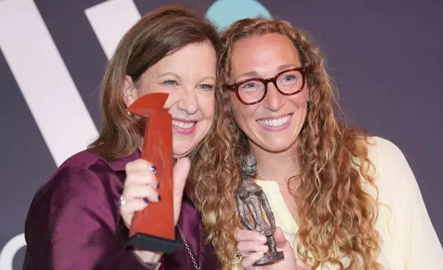 Virginia Evans, right, and Lyse Doucet winners of The Women's Prize for fiction and nonfiction, left, pose for a photograph at the 2026 Women's Prize Trust Summer Party &amp; Awards Ceremony in London, Thursday, June 11, 2026. (AP Photo/Kin Cheung)