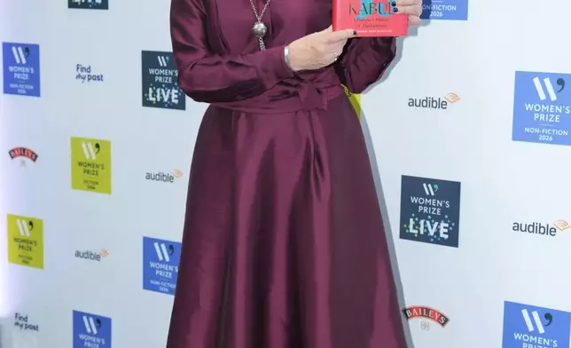 Lyse Doucet holding her book The Finest Hotel in Kabul: A People's History of Afghanistan, poses for a photograph at the 2026 Women's Prize Trust Summer Party &amp; Awards Ceremony in London, Thursday, June 11, 2026. (AP Photo/Kin Cheung)