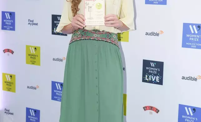 Virginia Evans holding her book The Correspondent, poses for a photograph at the 2026 Women's Prize Trust Summer Party &amp; Awards Ceremony in London, Thursday, June 11, 2026. (AP Photo/Kin Cheung)
