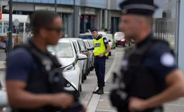 French police officers check cars crossing the border between Geneva and the French town of Gaillard, France, Wednesday, June 10, 2026, ahead of the upcoming G7 summit due to take place June 15-17 in the town of Evian-les-Bains. (AP Photo/Baz Ratner)