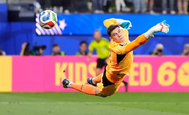 Paraguay goalkeeper Orlando Gill is airborne as he fails to stop a goal from United States' Giovanni Reyna during the World Cup Group D soccer match between the United States and Paraguay in Inglewood, Calif., near Los Angeles, Friday, June 12, 2026. (AP Photo/Mark J. Terrill)