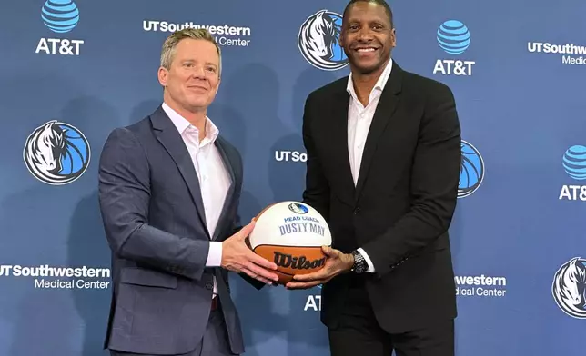 New Dallas Mavericks coach Dusty May, left, poses with president of basketball operations Masai Ujiri, right, during May's introductory NBA news conference in Dallas, Monday, June 29, 2026. (AP Photo/Schuyler Dixon)
