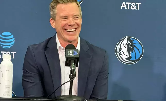 New Dallas Mavericks coach Dusty May smiles while responding to a question during his introductory NBA basketball news conference in Dallas, Monday, June 29, 2026. (AP Photo/Schuyler Dixon)