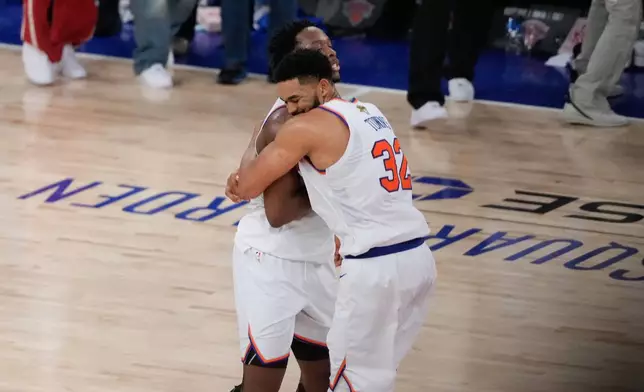New York Knicks center Karl-Anthony Towns (32) embraces forward Og Anunoby after Game 4 of the NBA Finals basketball series against the San Antonio Spurs, Wednesday, June 10, 2026, in New York. (AP Photo/Ross D. Franklin)