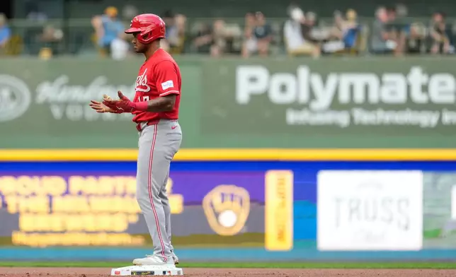 Cincinnati Reds' Dane Myers gestures after hitting an RBI double during the first inning of a baseball game against the Milwaukee Brewers, Monday, June 29, 2026, in Milwaukee. (AP Photo/Aaron Gash)