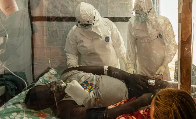 Health workers attend to an Ebola patient at the Rwampara treatment Center in Ituri, Congo, Thursday, June 18, 2026. (AP Photo/Moses Sawasawa)