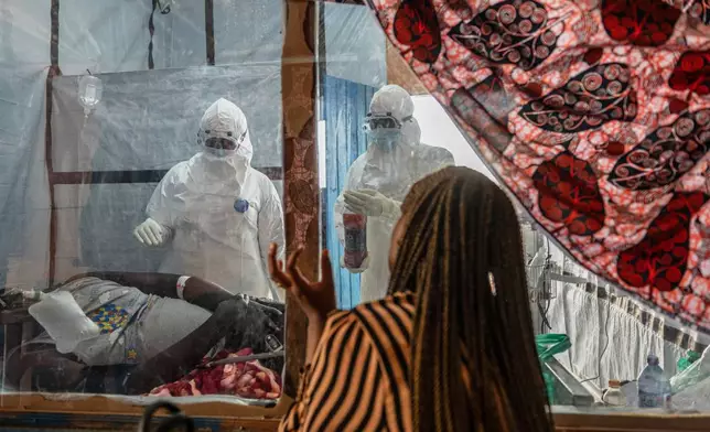 Health workers attend to an Ebola patient at the Rwampara treatment Center in Ituri, Congo, Thursday, June 18, 2026. (AP Photo/Moses Sawasawa)