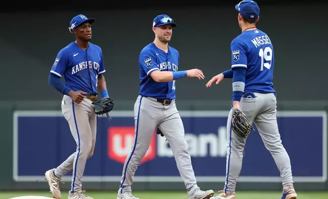 Kansas City Royals center fielder Lane Thomas, middle, and second baseman Michael Massey celebrate their teams win against the Minnesota Twins after a baseball game, Sunday, June 7, 2026, in Minneapolis. (AP Photo/Matt Krohn)