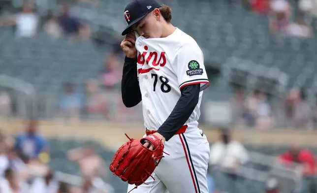 Minnesota Twins pitcher Andrew Morris wipes his face as he walks off the field during the fifth inning of a baseball game against the Kansas City Royals, Sunday, June 7, 2026, in Minneapolis. (AP Photo/Matt Krohn)