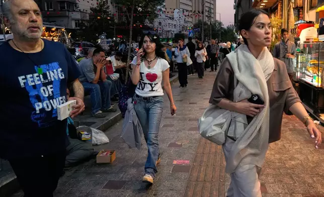 People walk along Tajrish square in northern Tehran, Monday, June 15, 2026. (AP Photo/Vahid Salemi)