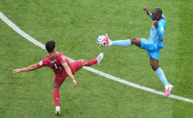 Portugal's Tomas Araujo (4), left, and Congo's Edo Kayembe (25) fight for the ball during the World Cup Group K soccer match between Portugal and Congo in Houston, Wednesday, June 17, 2026. (AP Photo/Eric Smith)