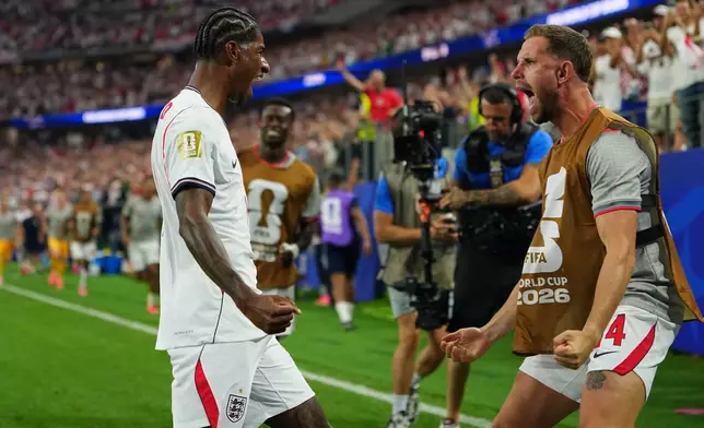 England's Marcus Rashford, left, celebrates scoring his side's 4th goal with Jordan Henderson during the World Cup Group L soccer match between England and Croatia in Arlington, Texas, near Dallas, Wednesday, June 17, 2026. (AP Photo/Julio Cortez)