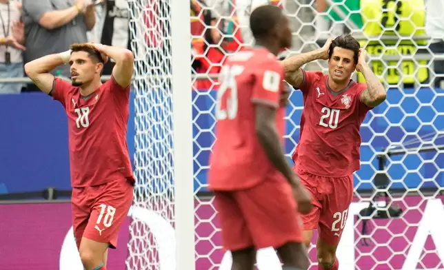 Portugal's Pedro Neto, left, and Portugal's Joao Cancelo react during the World Cup Group K soccer match between Portugal and Congo in Houston, Wednesday, June 17, 2026. (AP Photo/Karen Warren)