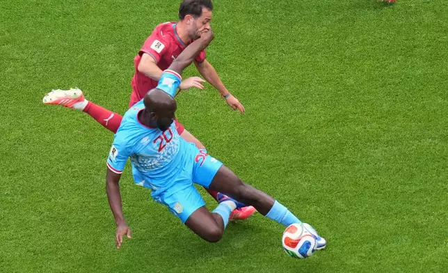 Congo's Yoane Wissa (20), front, and Portugal's Bernardo Silva (10) fight for the ball during the World Cup Group K soccer match between Portugal and Congo in Houston, Wednesday, June 17, 2026. (AP Photo/Eric Smith)
