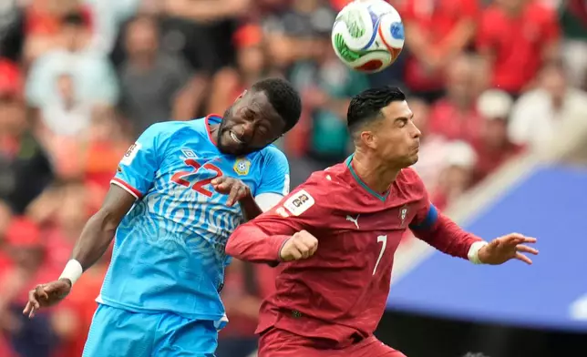 Portugal's Cristiano Ronaldo, right, and Congo's Chancel Mbemba jump for the ball during the World Cup Group K soccer match between Portugal and Congo in Houston, Wednesday, June 17, 2026. (AP Photo/Karen Warren)