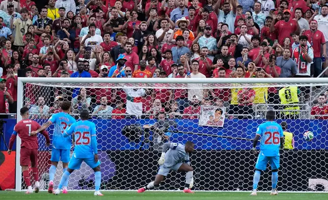 Portugal's Cristiano Ronaldo, left, watches as Congo goalkeeper Lionel Mpasi fails to save the opening goal by Portugal's Joao Neves during the World Cup Group K soccer match between Portugal and Congo in Houston, Wednesday, June 17, 2026. (AP Photo/Ashley Landis)