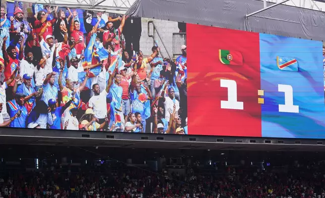 Celebrateing Congo fans are seen on a big screen after the World Cup Group K soccer match between Portugal and Congo in Houston, Wednesday, June 17, 2026. (AP Photo/Eric Smith)
