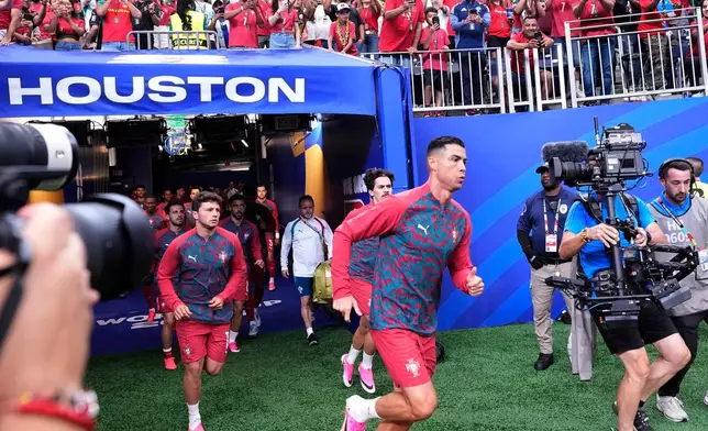 Portugal's Cristiano Ronaldo and teammates enter the pitch for the warm up before the World Cup Group K soccer match between Portugal and Congo in Houston, Wednesday, June 17, 2026. (AP Photo/Karen Warren)