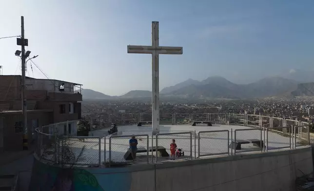 Residents stand at the Mirador overlooking the El Porvenir neighborhood in Trujillo, Peru, Sunday, May 24, 2026. (AP Photo/Rodrigo Abd)