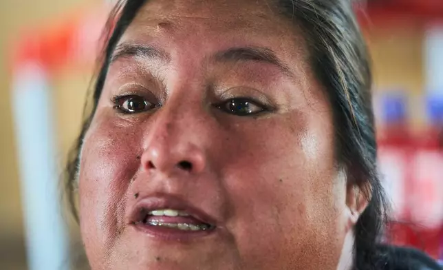 Gladys Saavedra, who works at an open-air market in Alto Trujillo and says she has been the target of gang extortion since 2018, speaks during an interview in Trujillo, Peru, Wednesday, May 27, 2026. (AP Photo/Rodrigo Abd)