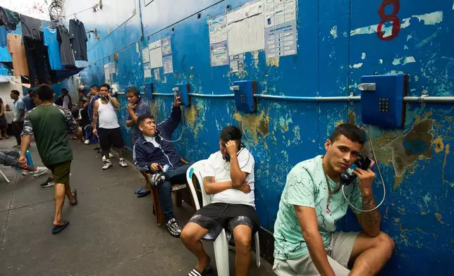 Inmates make phone calls at El Milagro Prison in Trujillo, Peru, Wednesday, May 20, 2026. (AP Photo/Rodrigo Abd)
