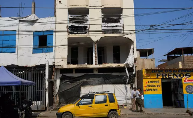 A building damaged in an explosives attack that police say was linked to extortion stands in Trujillo, Peru, Monday, May 18, 2026. (AP Photo/Rodrigo Abd)