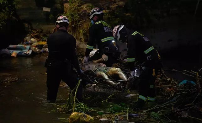 Police officers carry the body of Jose Perez from the ravine where he was found shot in Trujillo, Peru, Friday, May 30, 2026.(AP Photo/Rodrigo Abd)
