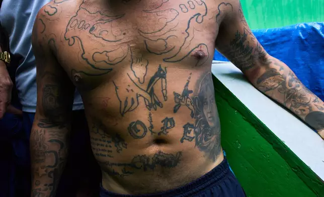An inmate lines up for lunch at El Milagro Prison in Trujillo, Peru, Wednesday, May 20, 2026. (AP Photo/Rodrigo Abd)