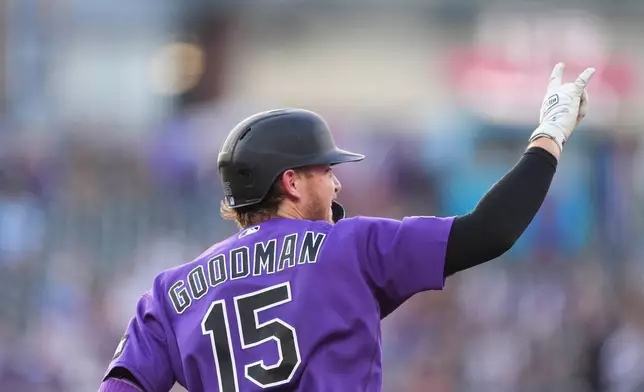 Colorado Rockies Hunter Goodman gestures to the bullpen as he circles the bases after hitting a two-run home run off Chicago Cubs starting pitcher Colin Rea in the first inning of a baseball game Tuesday, June 9, 2026, in Denver. (AP Photo/David Zalubowski)