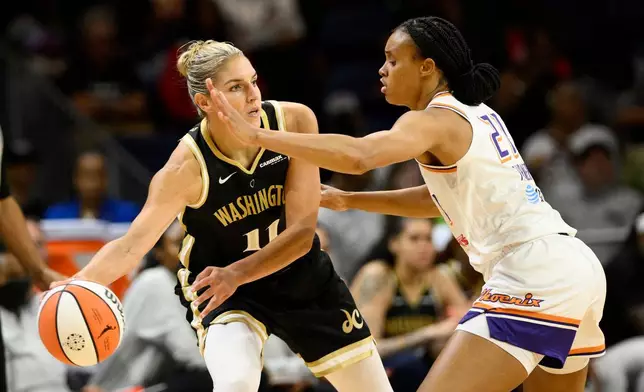 FILE - Washington Mystics forward Elena Delle Donne (11) looks to pass the ball as Phoenix Mercury forward Brianna Turner (21) defends during the first half of a WNBA basketball game, June 16, 2023, in Washington. (AP Photo/Nick Wass, File)