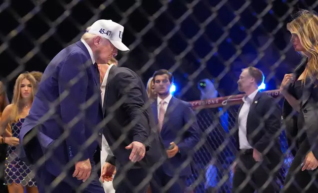 President Donald Trump and first lady Melania Trump stand in the ring at UFC Freedom 250 on the South Lawn of the White House, Monday, June 15, 2026, in Washington. (AP Photo/Alex Brandon)